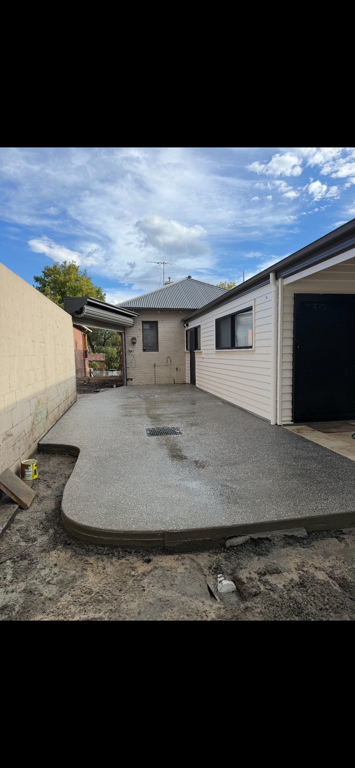 Fresh broom-finished concrete driveway in front of a residential property in Tasmania